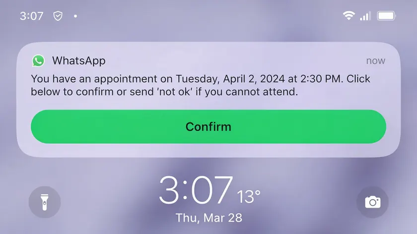Smartphone lock screen showing a WhatsApp appointment reminder notification with a confirm button.